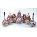 An associated 'garniture' of seven Japanese Imari vases,