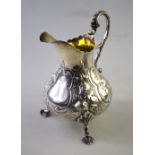 A Victorian silver pear-shaped cream jug in the Rococo Revival manner with floral and scroll chased