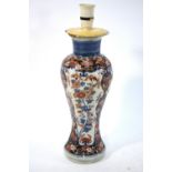 A Japanese Imari baluster vase on flaring foot and circular base, decorated with floral designs,