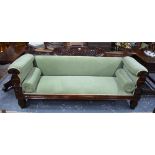 A Regency mahogany framed sofa with pale green upholstery, raised on moulded front legs,