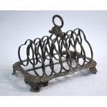 A George IV silver toast rack with reeded scroll divisions and shell and gadroon lower frame,