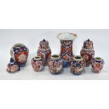 An associated Japanese Imari 'garniture' of seven small vases; each vase with a ribbed oviform body.