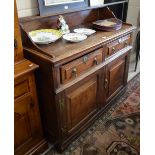 An 18th century oak North Country low dresser with raised shelf above two short and two long