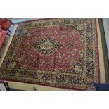 A large traditional Persian Meshad carpet, the central navy medallion,