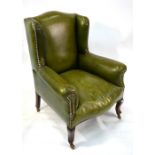 A late 19th century child's green leather library wing armchair, on cabriole front legs to castors,
