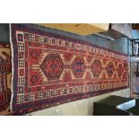 A Persian Tabriz runner with geometric medallions on camel field and red/ivory repeating borders,