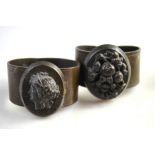 Two Victorian vulcanite bangles, one having applied vulcanite cameo in centre,