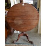 A Georgian mahogany tilt-top tea table on baluster pillar and tripod support,