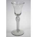 An 18th century wine glass, bell bowl, multiple spiral twist stem with swelled shoulder knop,