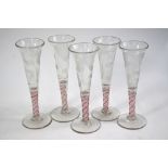 A set of five Jacobite style wine flutes, each having a trumpet bowl engraved with a rose.