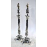 A pair of electroplated Empire style candlesticks with reeded columns and triform bases,