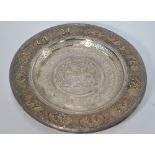 A Burmese white metal dish of circular form,