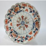 A Japanese Imari dish of kikugata form; decorated with kiku and floral designs;