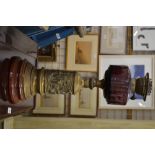 A Victorian oil lamp with amethyst glass font on embossed brass base
