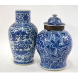 Two Chinese blue and white vases: one decorated with panels depicting birds perched beside peony,