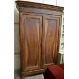A large 19th century French provincial walnut armoire of chateau proportion with twin panelled