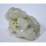 A green jade of pale or whitish hue, carved as a ram or goat,