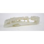 A Chinese green jade belt buckle of pale or whitish hue;
