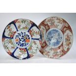 A large Japanese Imari dish of circular form, decorated in typical underglaze blue,