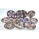 Eleven Japanese Imari dishes, all of kikugata form, decorated with typical flower, plant,
