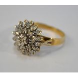 A 9ct gold three-tier cluster ring with illusion-set diamonds