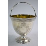 A Victorian ovoid silver bonbon basket with beaded swing handle and stemmed foot,