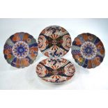 Two pairs of Japanese Imari dishes: one pair of kikugata form decorated with brocade designs on