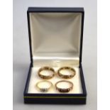 Collection of four stone set rings including white and red synthetic eternity ring,