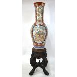A large Arita, or other Japanese, vase with polychrome enamel decoration and trumpet neck,