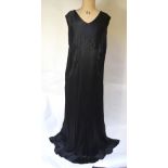 A 1930s bias-cut and inset black silk satin evening dress with draped hem,
