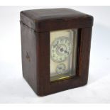 A brass carriage clock with alarm striking on bell,