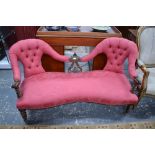 A moulded mahogany framed chair back sofa over a serpentine form seat,