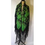 A Chinese dark blue silk fringed shawl printed with jade green flowering peony design,