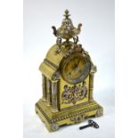 An ornate French gilt brass and mixed metal cased 8-day mantel clock, surmounted by an urn,