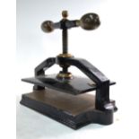 A heavy Victorian cast iron and brass book-press,