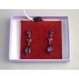 A pair of amethyst drop earrings, of good colour, yellow metal, in gallery style claw setting,