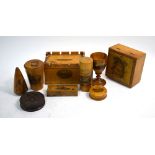 A Mauchlin ware dice-box, castellated money box, needle case and egg-cup,