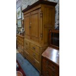 An oak two part linen cabinet,