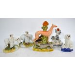 A pair of Victorian Staffordshire figure groups - milkmaid and cow and herdsman and cow,