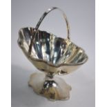 An Adam-style silver bonbon basket of navette form, with swing handle and stemmed foot,