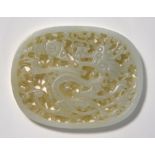 An oval, green jade plaque of oval and reticulated form, decorated with a dragon, 6.