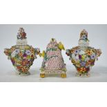 A pair of 19th century of porcelain pot pourri vases and covers decorated in bold relief with