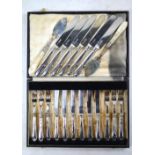 A set of six Edwardian silver-bladed tea knives with foliate loaded handles,