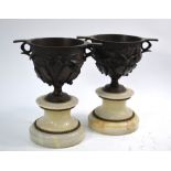 A pair of 19th century brown patinated bronze garniture vases, cast with fruiting ivy,