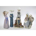 Four Lladro figures - Girl with umbrella and pots by her feet, 30 cm; Boy and girl courting, 12.