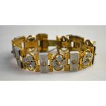A Victorian gilt metal linked bracelet with applied decorative aluminium panels featuring engraved