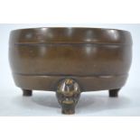 A bronze incense burner of circular form