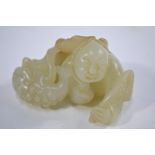 A mottled green jade carved as a boy wit