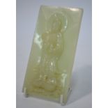 A green jade plaque of whitish hue, carv