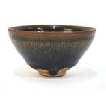 A mottled glazed, conical bowl decorated
